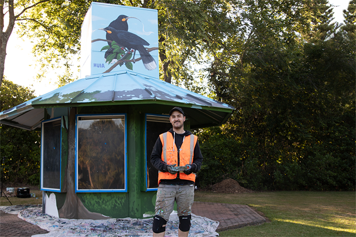 Joe in front of Information Kiosk Mural.